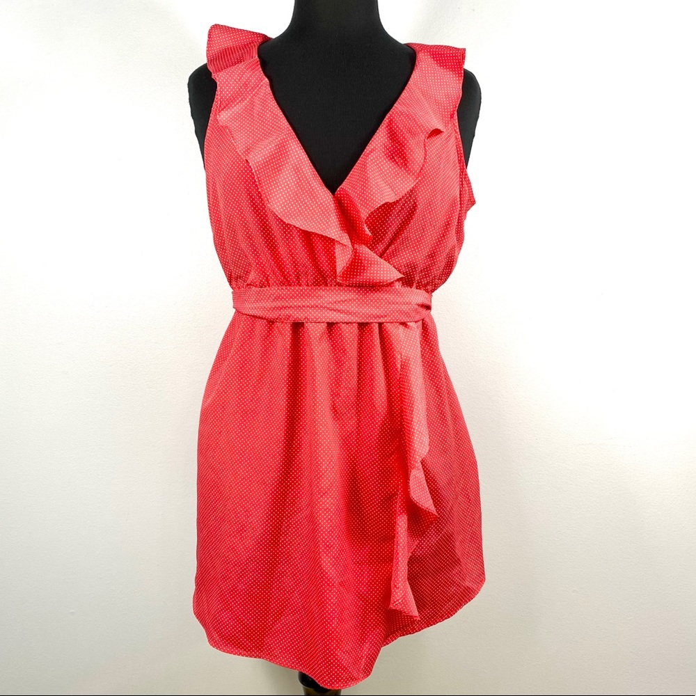 Polka dot sleeveless blouse with frills.